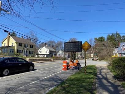 At an intersection in a residential area, a construction sign faces toward incoming traffic.