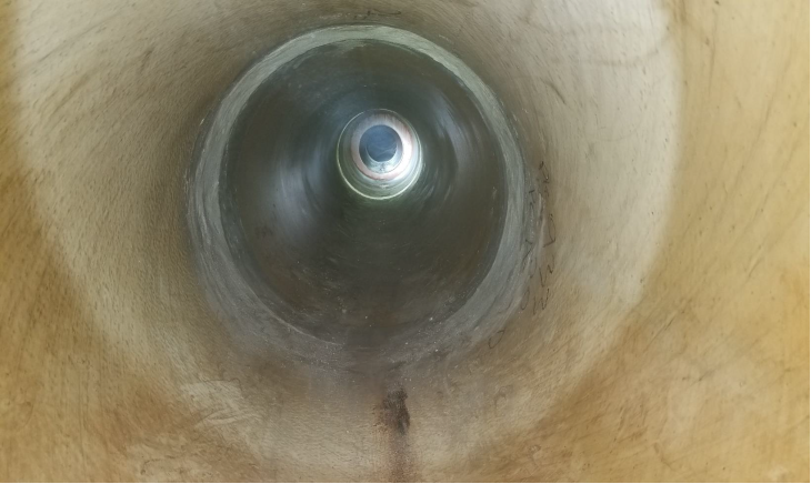 The inside of a large pipe.