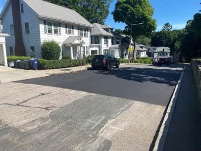 Final paving at access pits on Lake Street