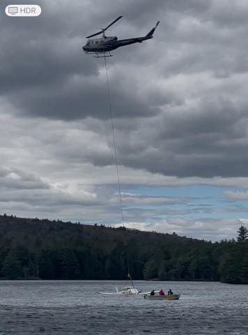 Helicopter successfully lifting the plane out of O'Laughlin Pond