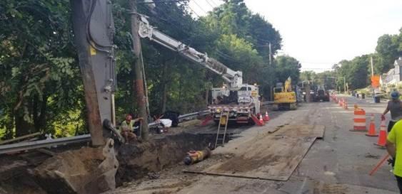36-inch pipe installation. the pipe is tight to one side but the work crew takes up most of the road